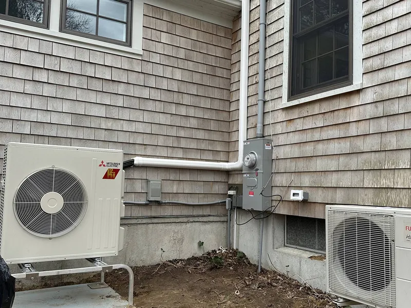 Heat pump units beside an electrical meter