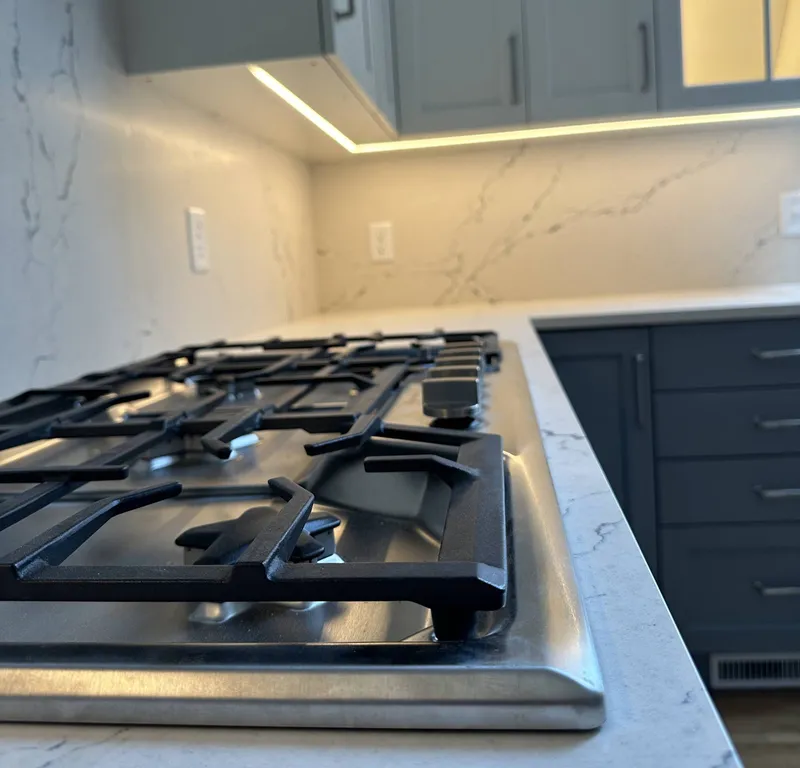 Under-cabinet lighting over a kitchen cooktop